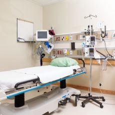 Empty hospital bed with emergency equipment